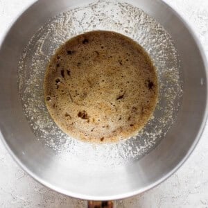 A metal pan with brown liquid in it.