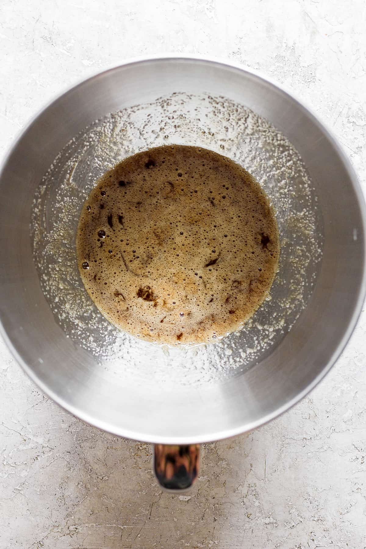 A metal pan with brown liquid in it.