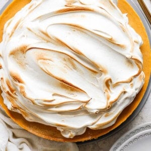 A pie with meringue topping on a plate.