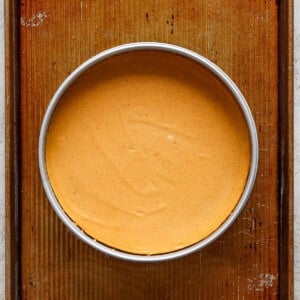 A bowl of pumpkin pie on a baking sheet.