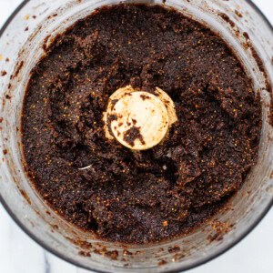 A food processor filled with a brown mixture.