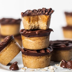 Peanut butter cups stacked on a plate.