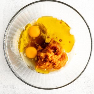 Two eggs in a glass bowl on a white background.