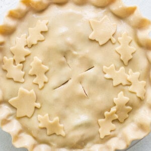 A pie with leaves on top of it.