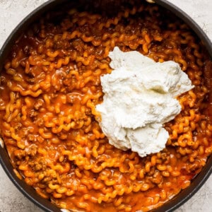 A pan filled with pasta and sour cream.