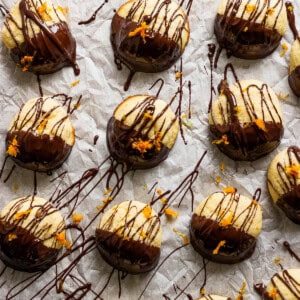 A bunch of chocolate covered donuts on a piece of paper.