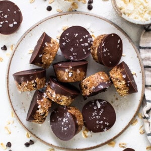 A plate topped with chocolate covered granola bars.