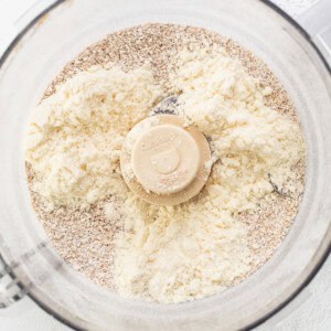 A food processor filled with flour and other ingredients.