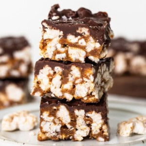 A stack of chocolate graham cracker bars on a plate.