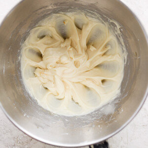 A bowl of whipped cream in a metal bowl.