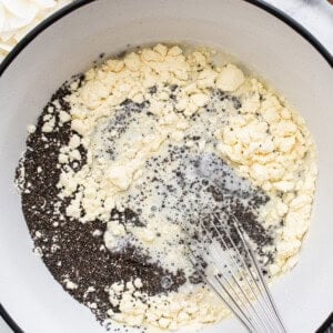 A bowl of ingredients in a pan with a wooden spoon.