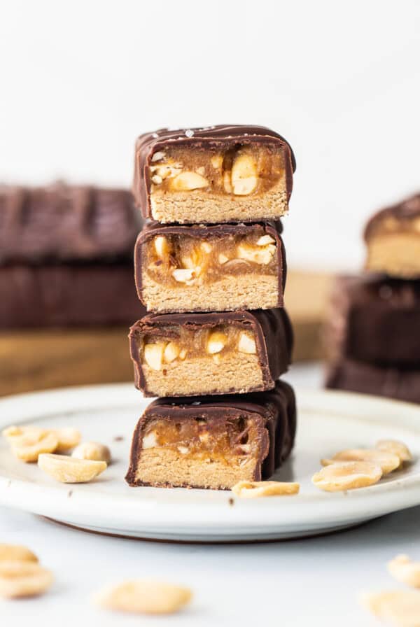 A stack of chocolate peanut butter bars on a plate.