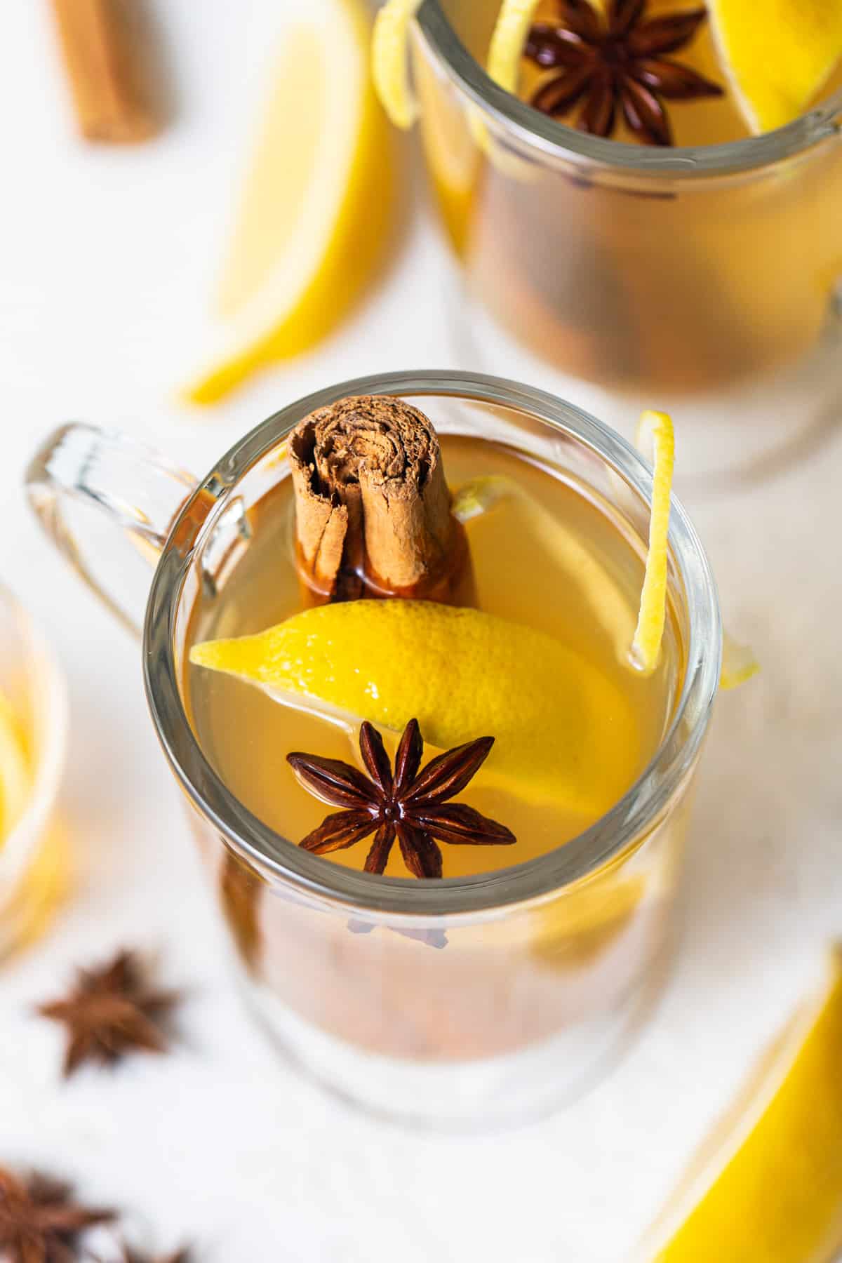 A cup of mulled cider with cinnamon sticks and star anise.