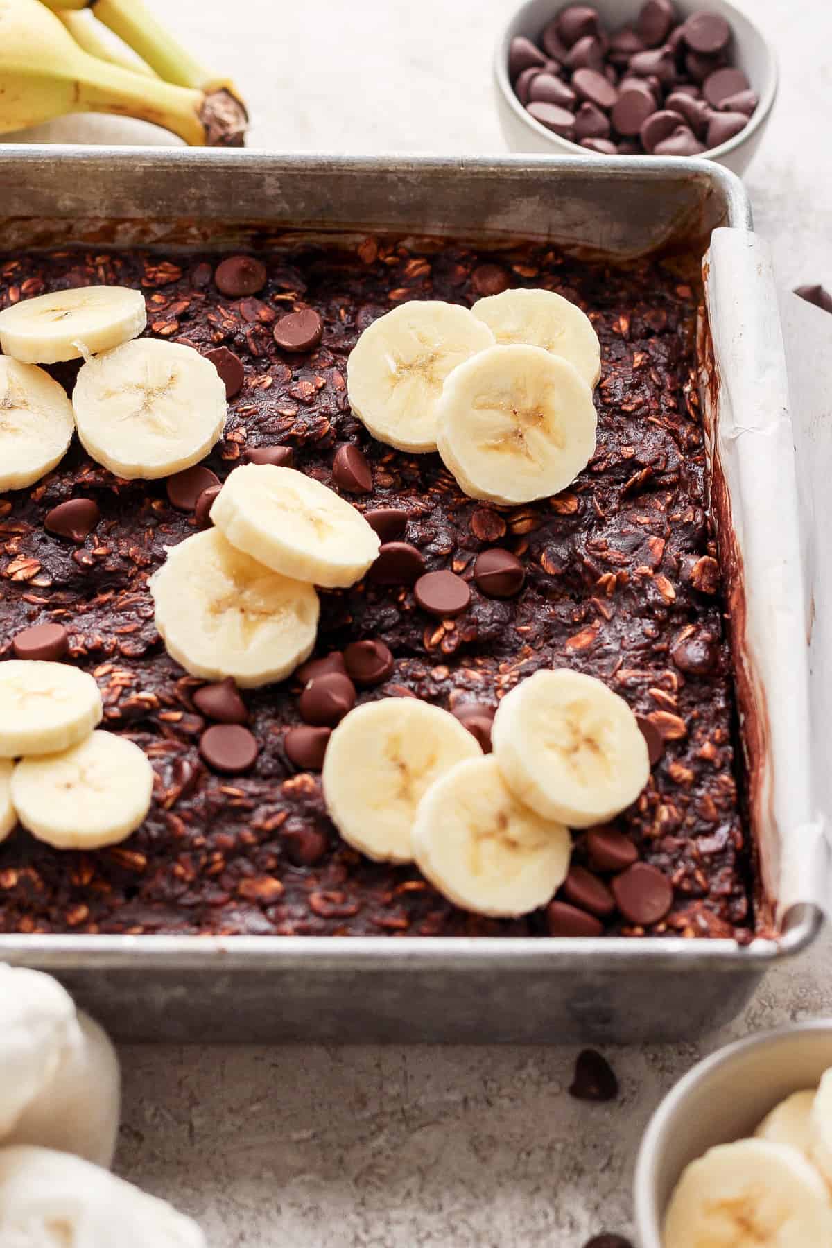 A baking pan filled with bananas and chocolate chips.