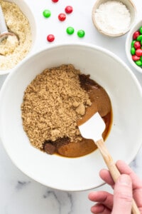A person mixing ingredients in a bowl.