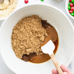 A person mixing ingredients in a bowl.