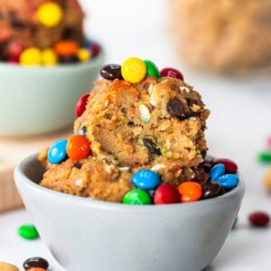 A bowl filled with cookies and m&m's.