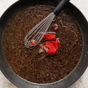 A frying pan with a red pepper in it.