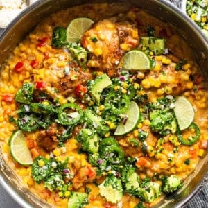 A bowl of chicken curry with vegetables and rice.