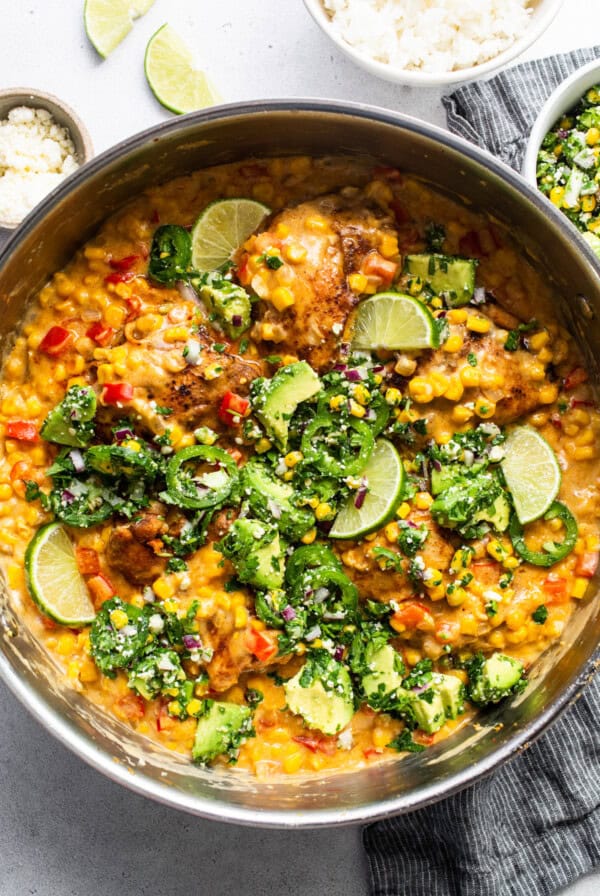 A bowl of chicken curry with vegetables and rice.