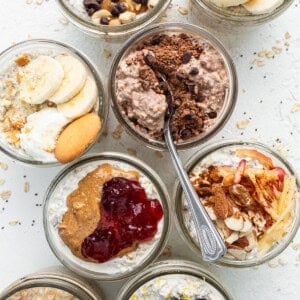 A bowl of oatmeal with berries, bananas, and granola.