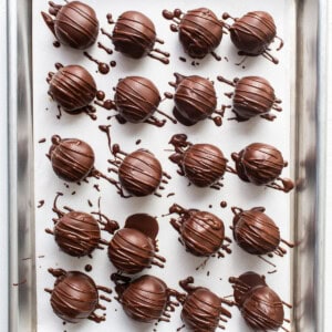 Chocolate truffles on a baking sheet.