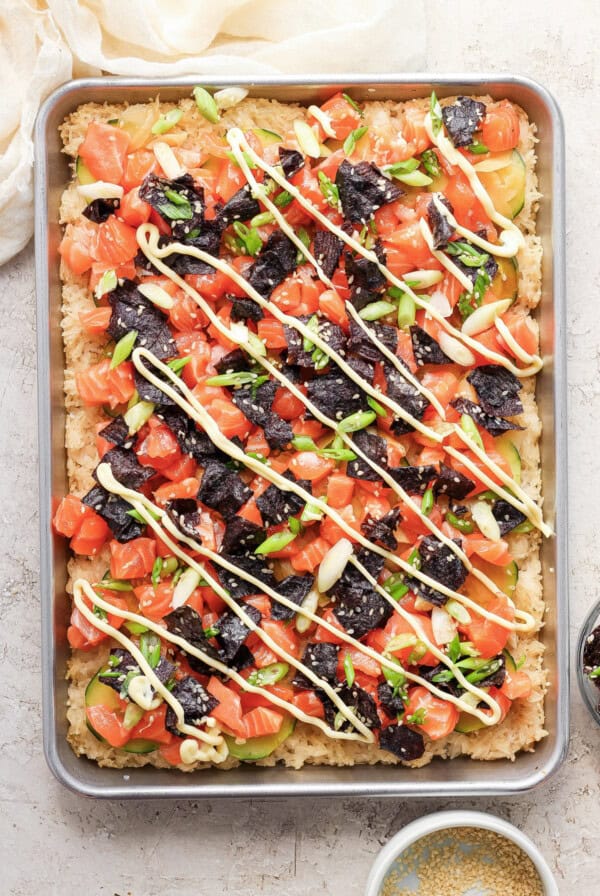 A tray with a pizza with toppings on it.