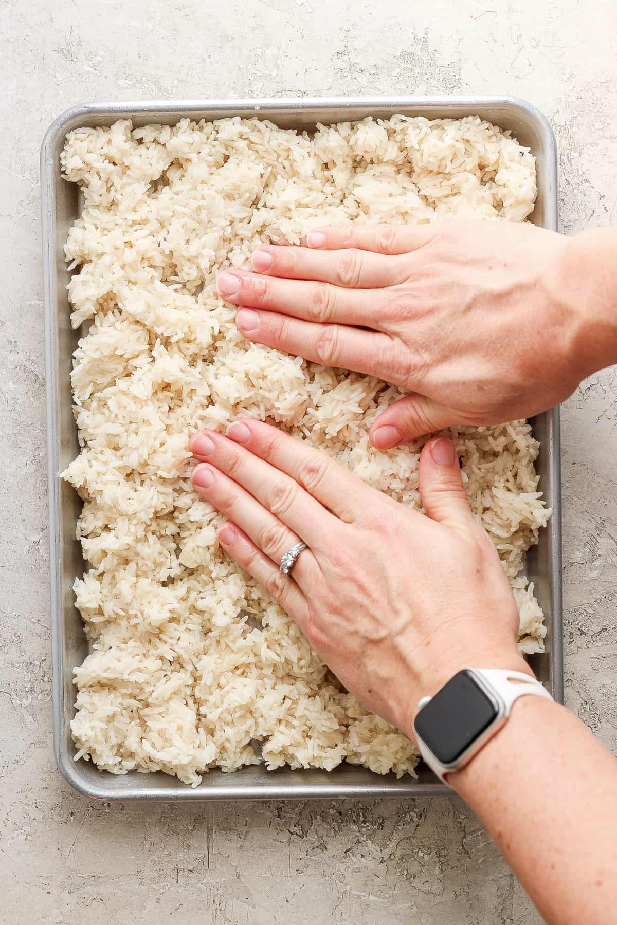 A person putting rice into a pan.