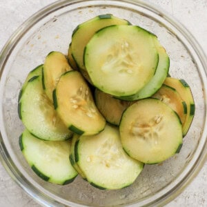 Sliced cucumbers in a glass bowl.