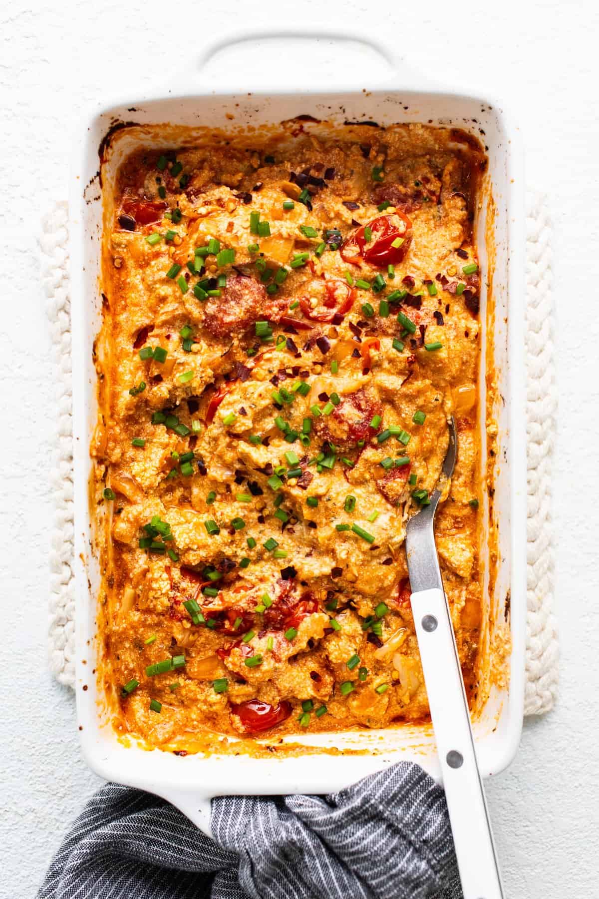 A casserole dish with a fork in it.