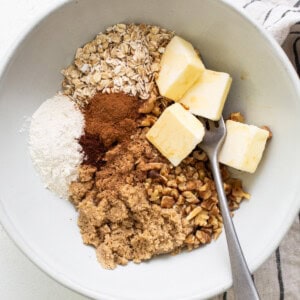 Oats, cinnamon, butter and sugar in a bowl.