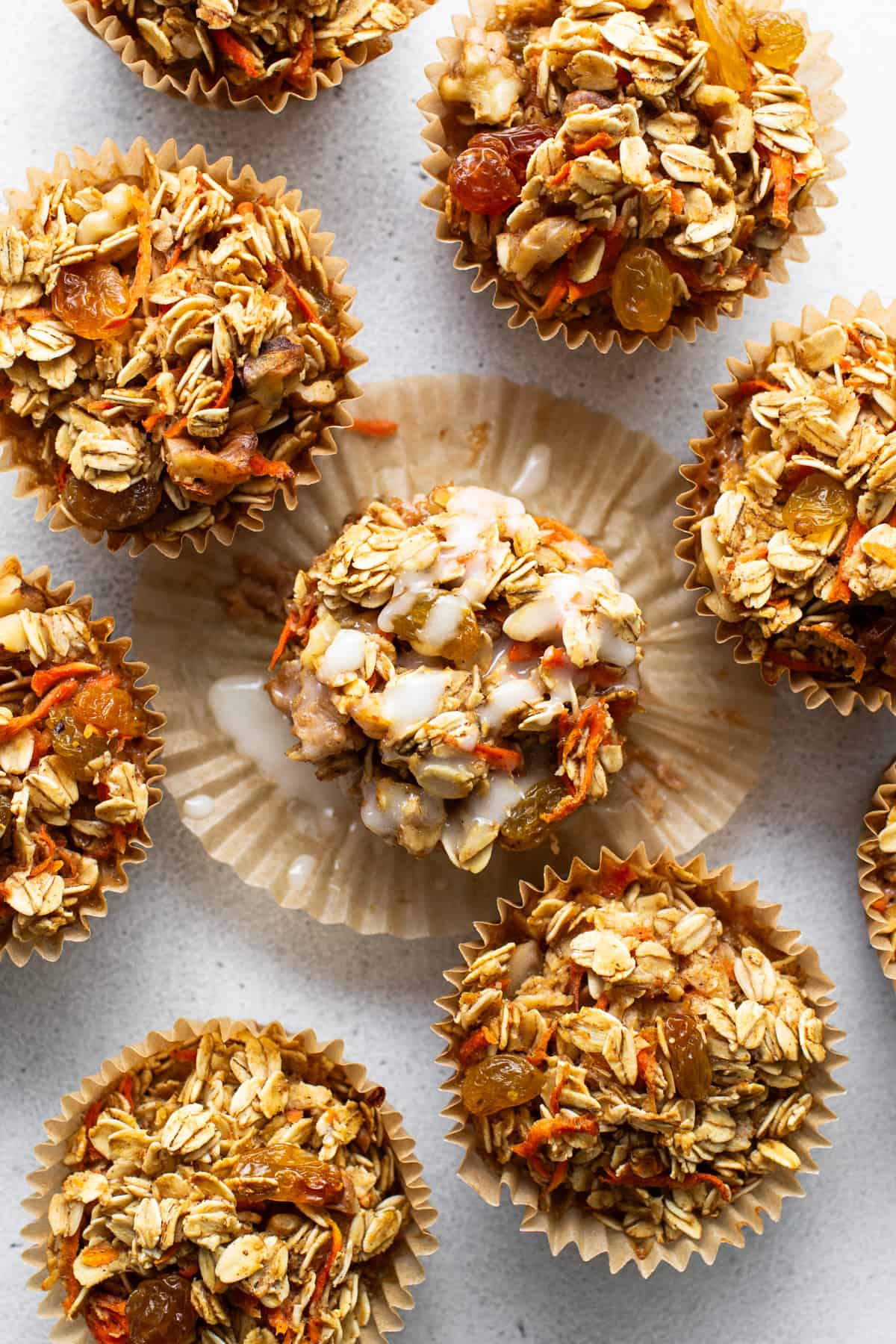 A group of granola muffins on a white surface.