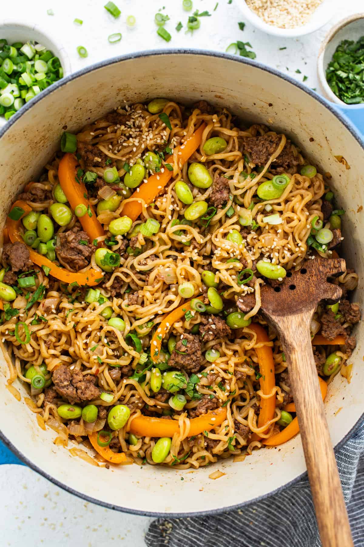 A bowl of noodles with meat and vegetables in it.