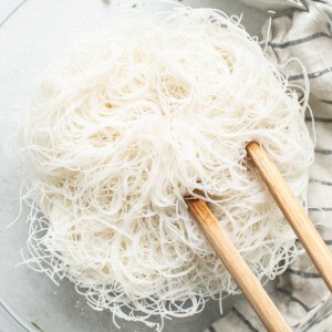 Noodles in a bowl with chopsticks.