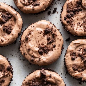 Chocolate cupcakes with chocolate frosting and chocolate chips.