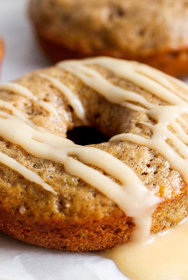 A banana-flavored donut with a glaze topping on a white background.