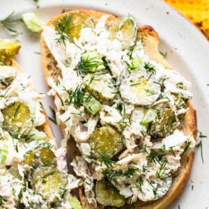 Chicken salad with pickles and dill on toasted bread.