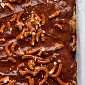 A tray of chocolate-covered toffee topped with pretzels.