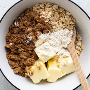 Ingredients for baking in a bowl with a wooden spoon.