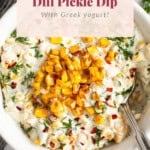 A bowl of sweet corn dill pickle dip with Greek yogurt, garnished with corn kernels and herbs, and a spoon in the bowl. Text overlay reads "SWEET CORN Dill Pickle Dip With Greek yogurt!.