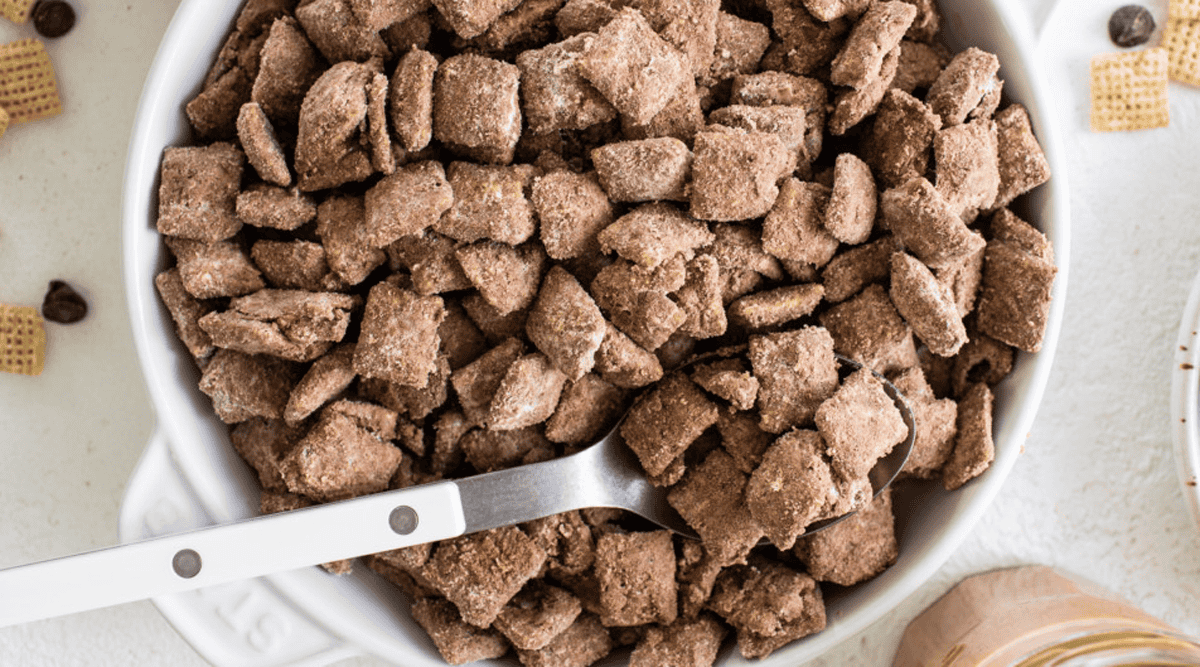 A bowl of chocolate-coated cereal pieces with a spoon.