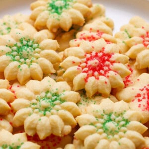 A plate of star-shaped cookies with red and green sprinkles.